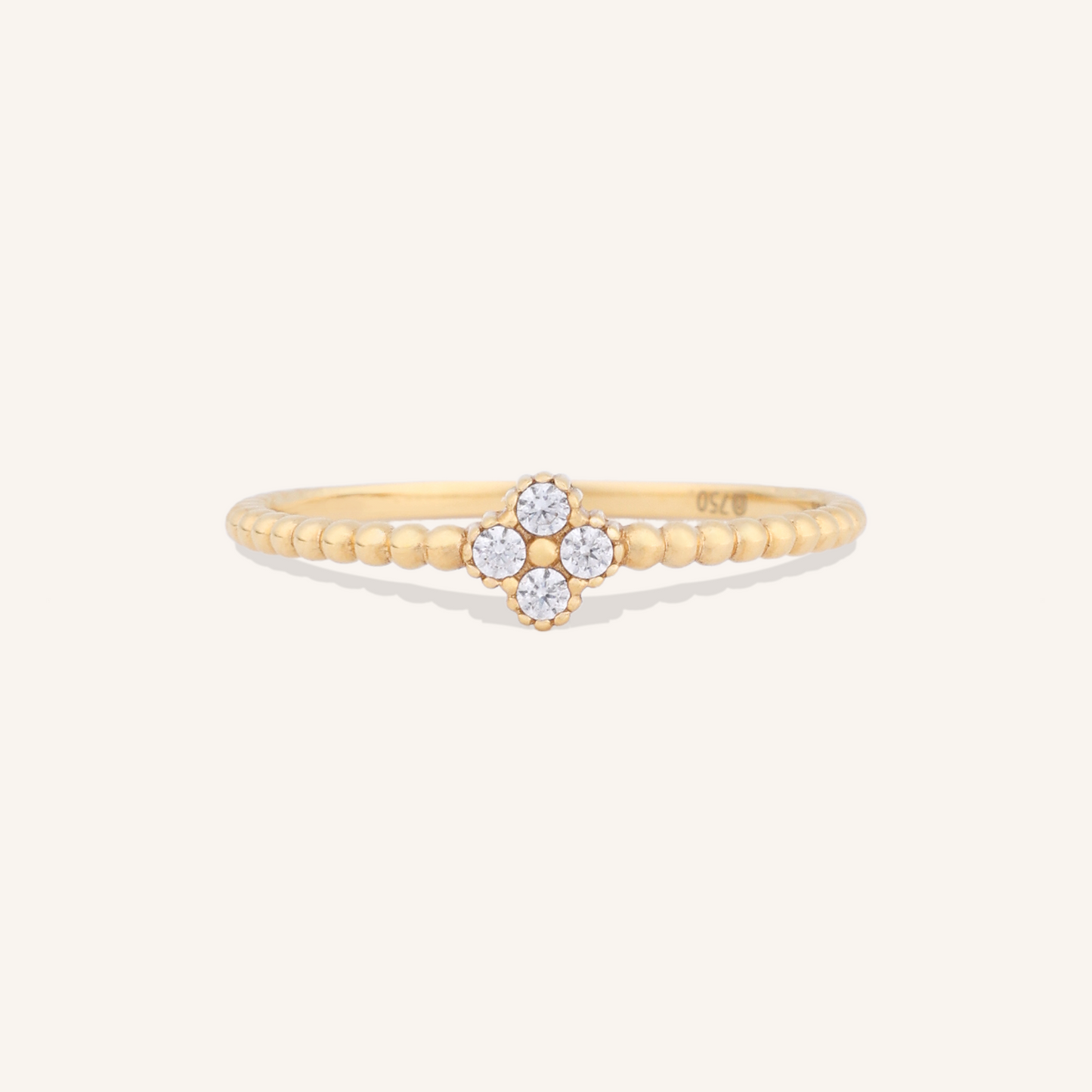 Gold ring with floral design on a white background